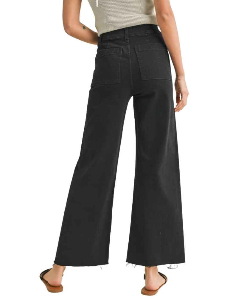 FADE BLACK pants worn by a woman on a white background