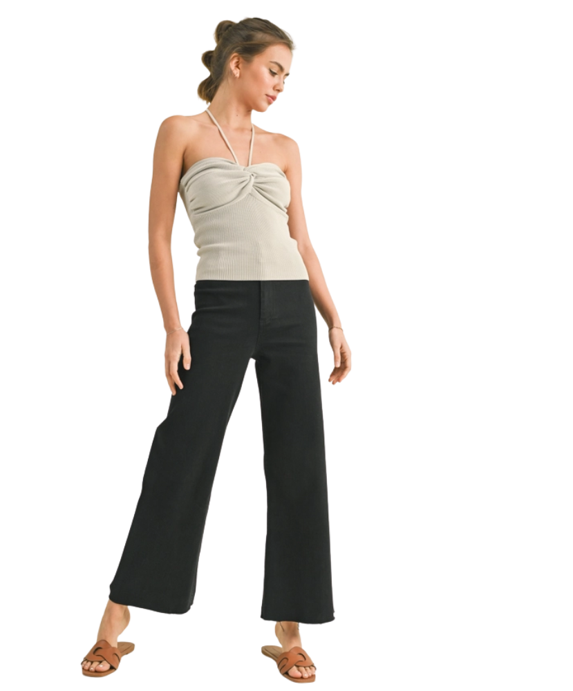 FADE BLACK pants worn by a woman on a white background