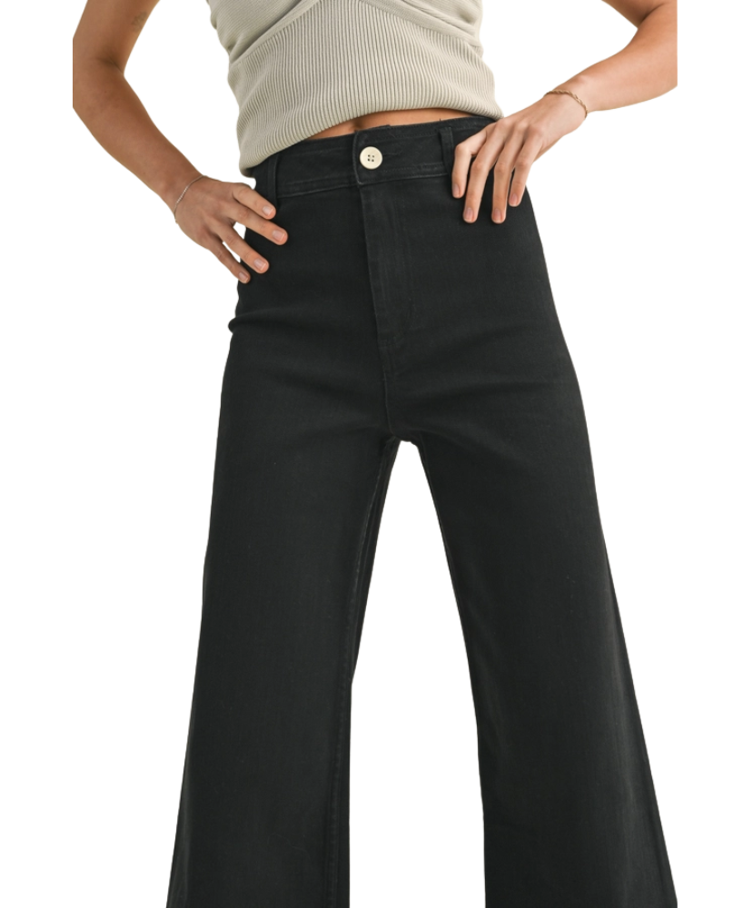 FADE BLACK pants worn by a woman on a white background