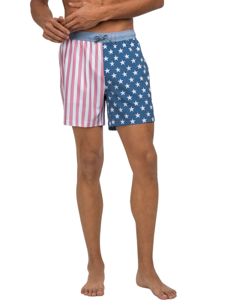 Person wearing American flag patterned swim shorts on a white background