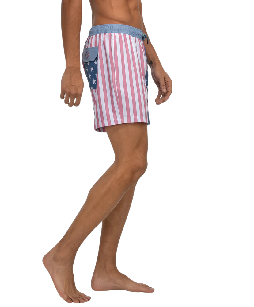 Person wearing American flag patterned swim shorts on a white background