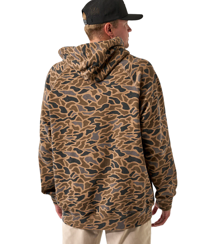 Person wearing a camouflage hoodie jacket and cap on a white background