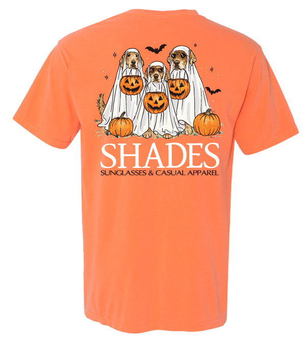 Orange t-shirt with Halloween-themed design of dogs in ghost costumes and pumpkins, featuring the brand 'SHADES'.
