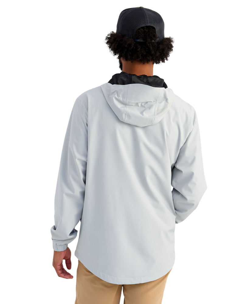 Man wearing a light gray HUK jacket and cap with a logo on a white background