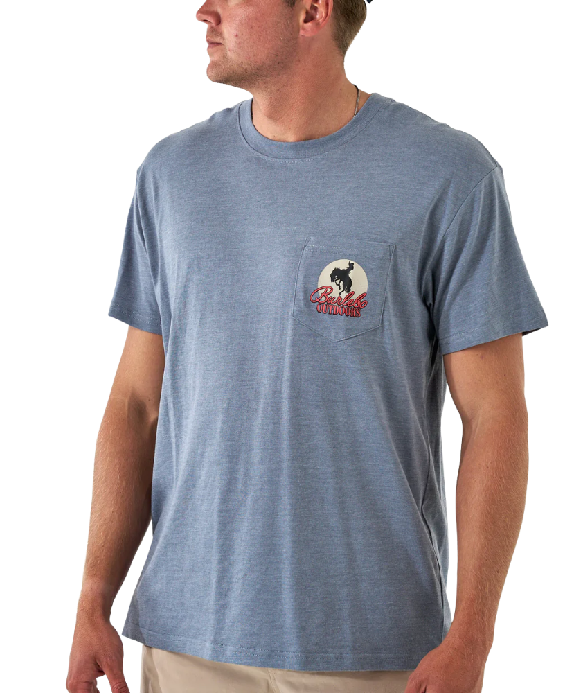 Man wearing a blue t-shirt with a logo on the chest pocket against a white background