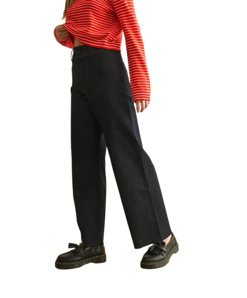 Person wearing a red striped shirt and black pants on a white background