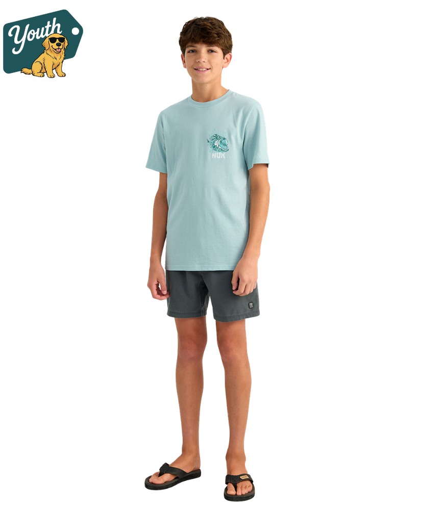 KID wearing a light blue HUK t-shirt with a bass design on the back, standing against a white background.