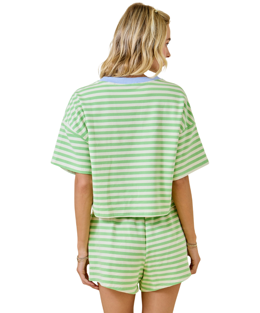 Woman wearing a green and white striped outfit on a white background