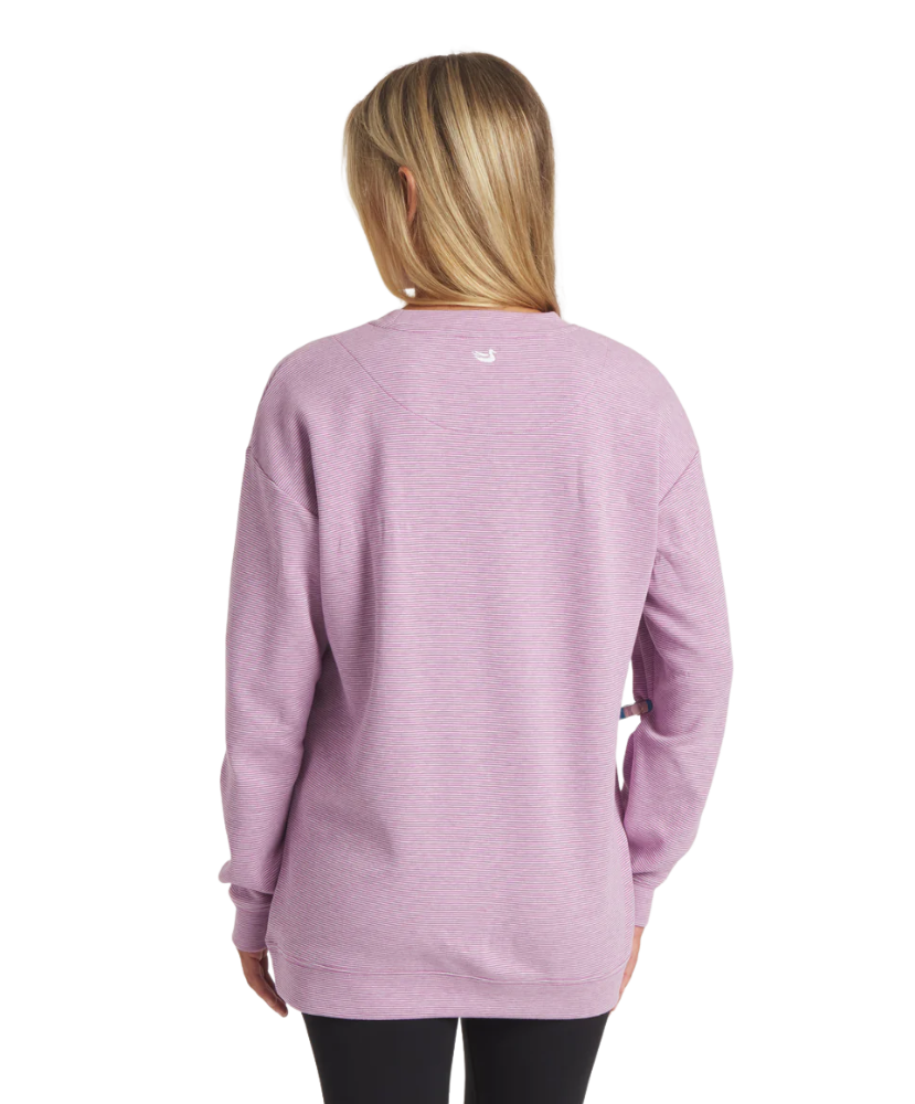 Person wearing a purple sweatshirt with a visible brand logo on the back.