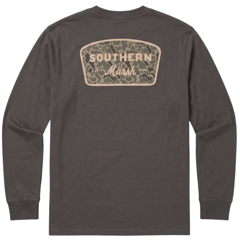 A dark brown long-sleeve t-shirt shown from the back, featuring a camouflage-patterned shield-shaped graphic with 'SOUTHERN Marsh' printed in beige.