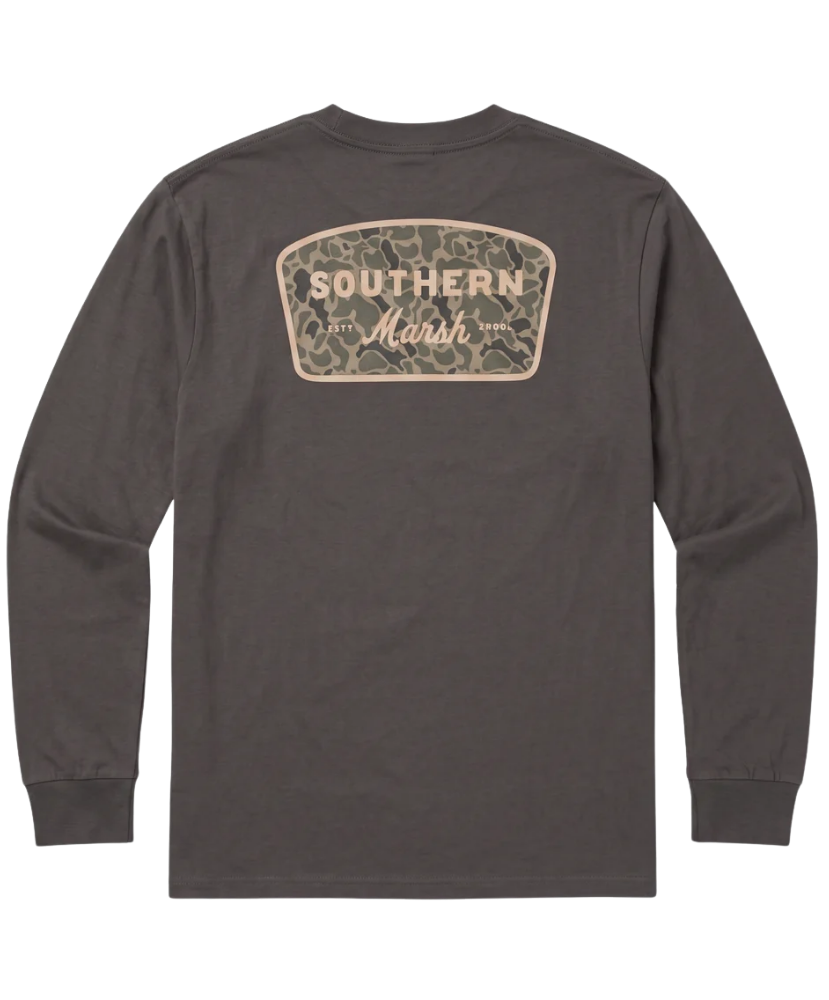 A dark brown long-sleeve t-shirt shown from the back, featuring a camouflage-patterned shield-shaped graphic with 'SOUTHERN Marsh' printed in beige.