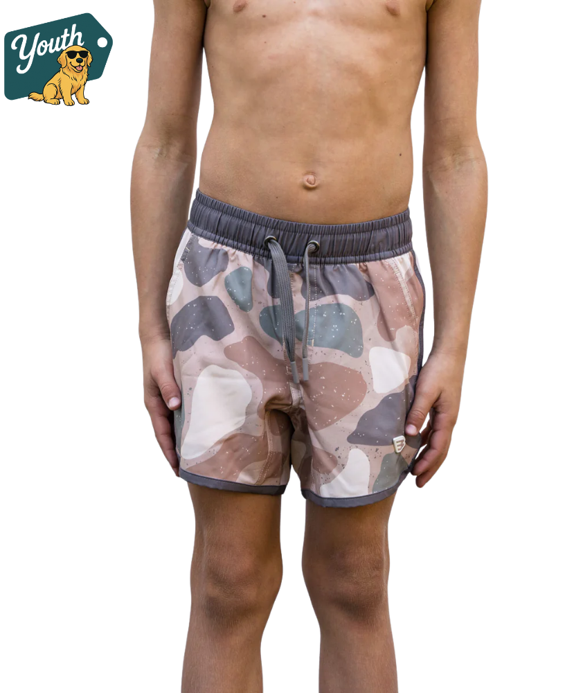 Person wearing camouflage SWIM shorts on a transparent background