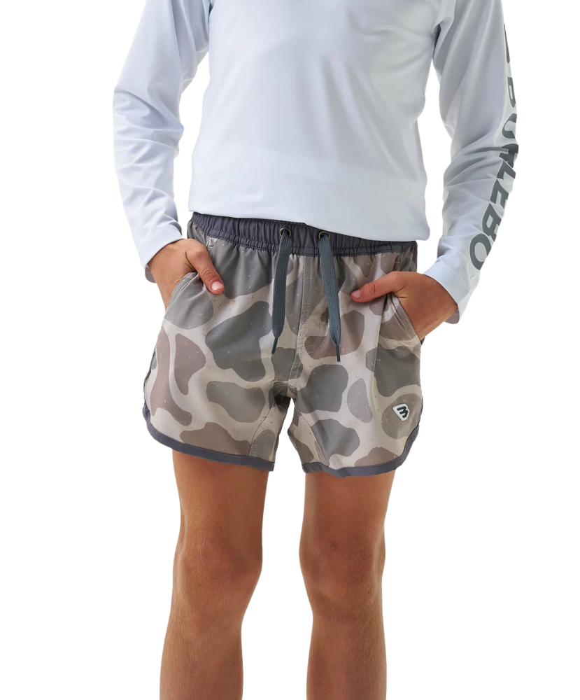 Camouflage kid's swim trunks with gray waistband on a white background, featuring a 'Youth' logo with a dog icon in the corner.