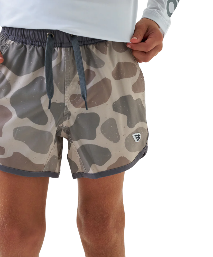Camouflage swim shorts worn by a person on a white background