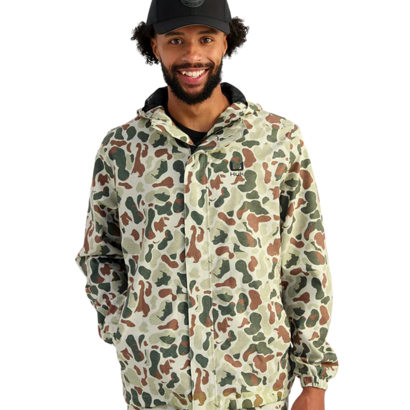 Man wearing a camouflage jacket and cap on a white background