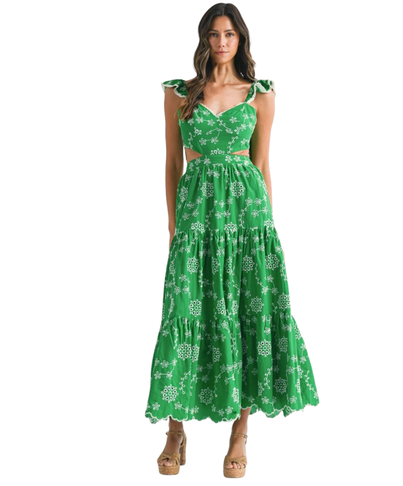 Woman wearing a green floral dress on a white background