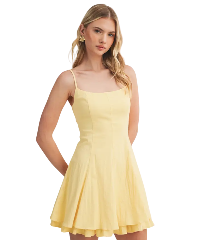 Woman wearing a yellow dress on a white background