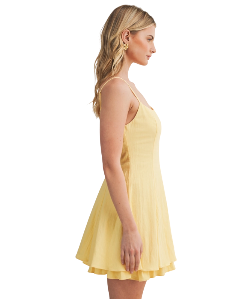 Woman wearing a yellow dress on a white background