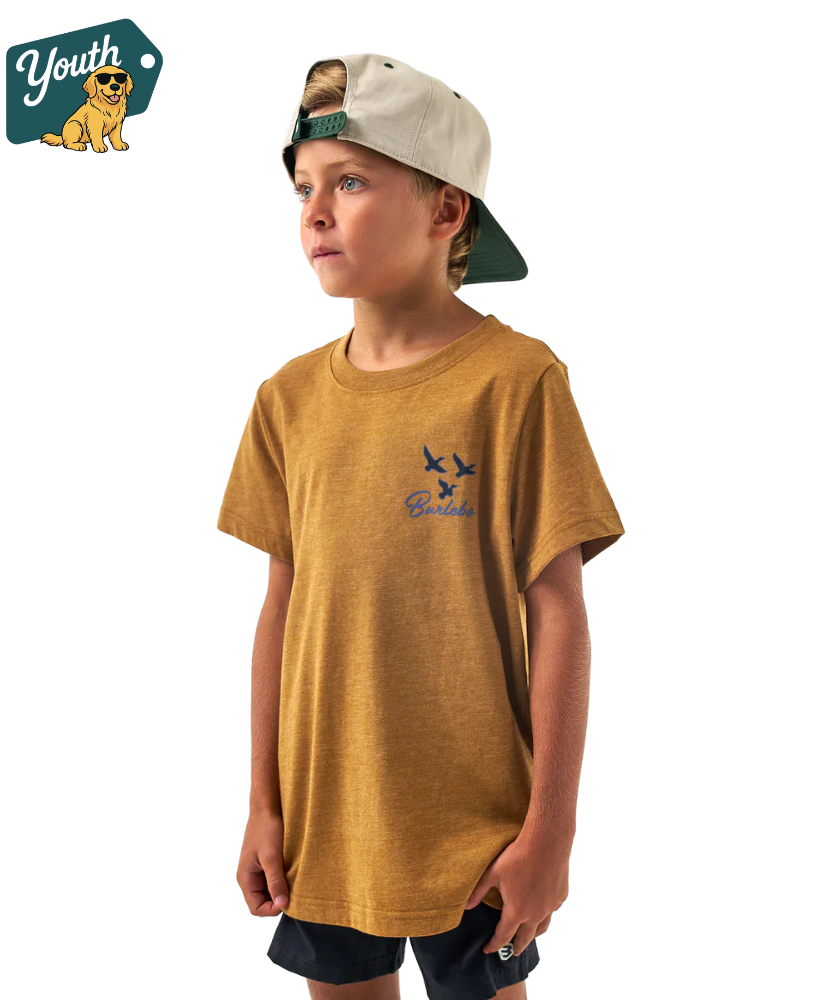 Child wearing a light brown t-shirt with a Burlebo logo and text, standing against a white background.