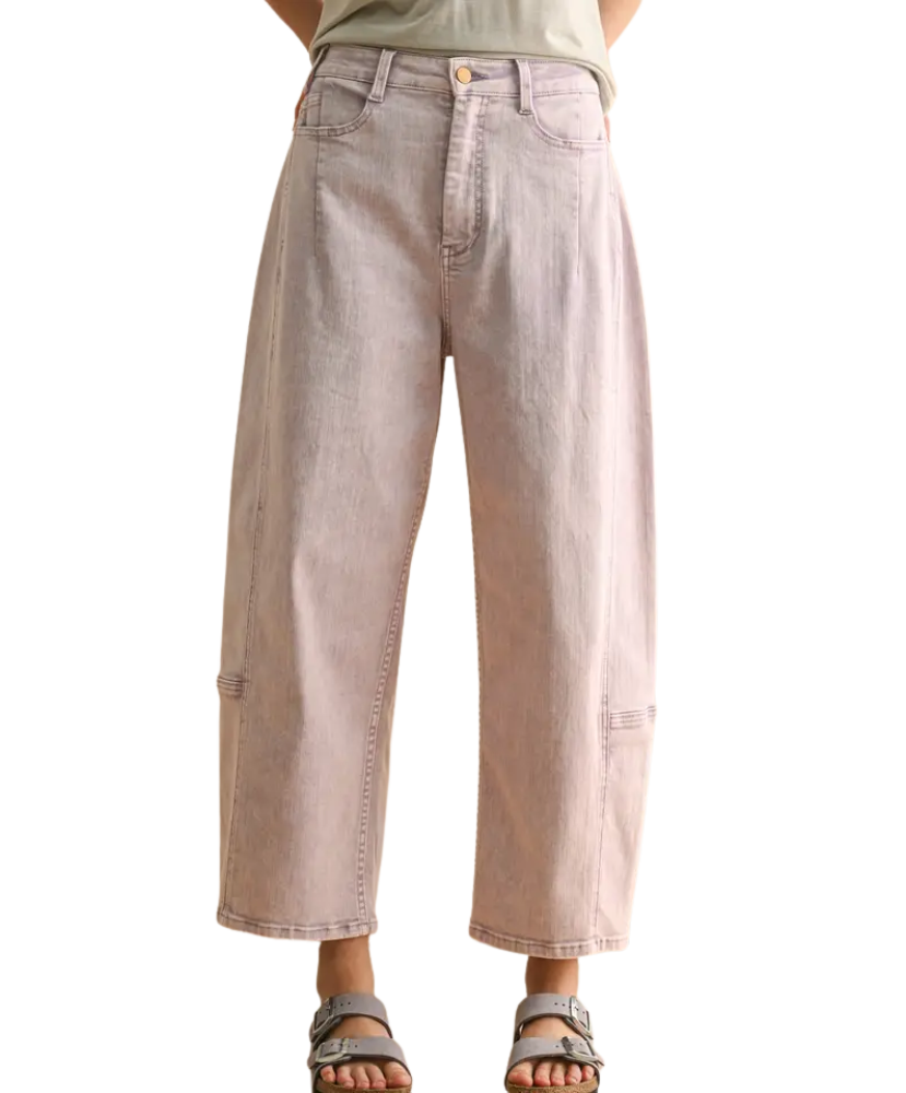 Light pink jeans worn by a person on a white background