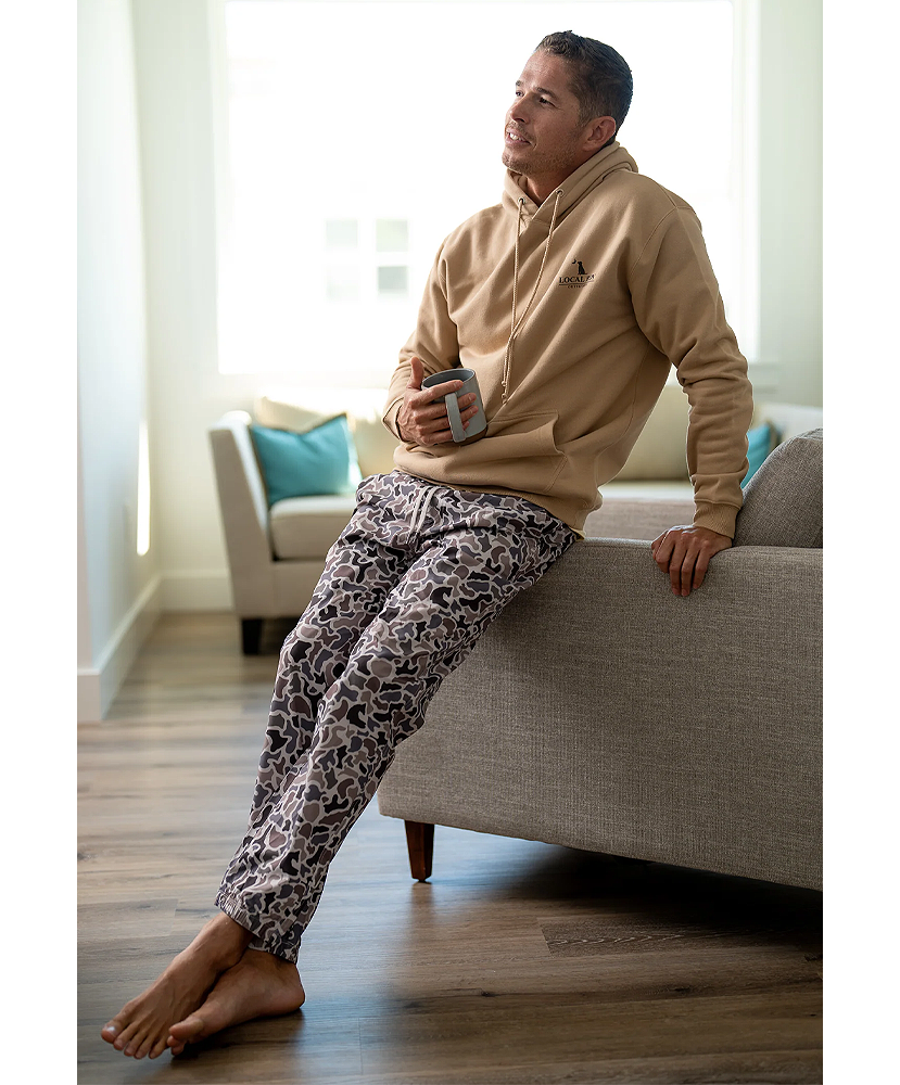 A pair of men's joggers with a camouflage pattern in muted colors.