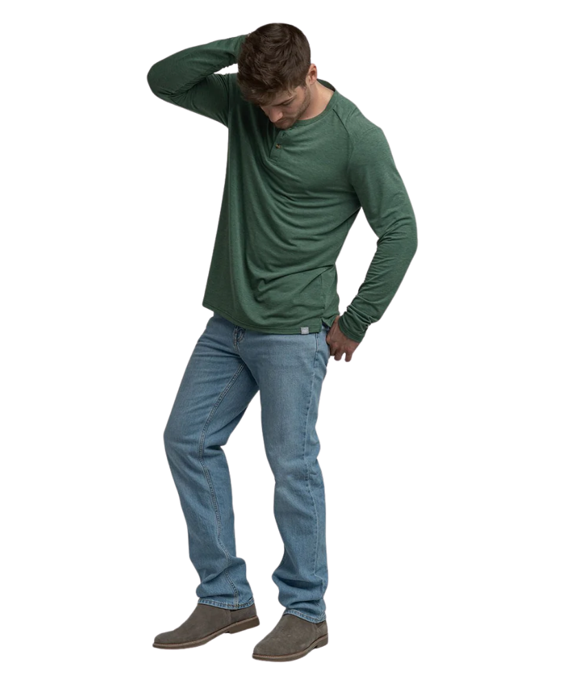Man wearing a green long-sleeve henley shirt and blue jeans on a white background