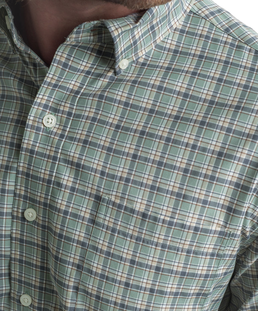 Close-up of a green plaid shirt with buttons