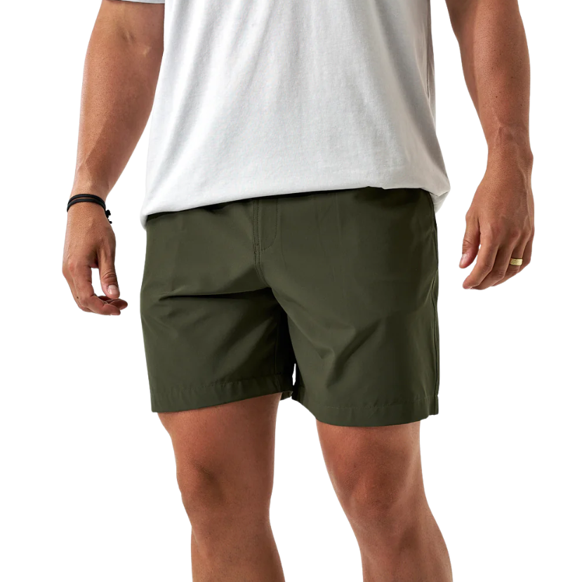 Person wearing green ATHLETIC shorts and a white t-shirt on a white background