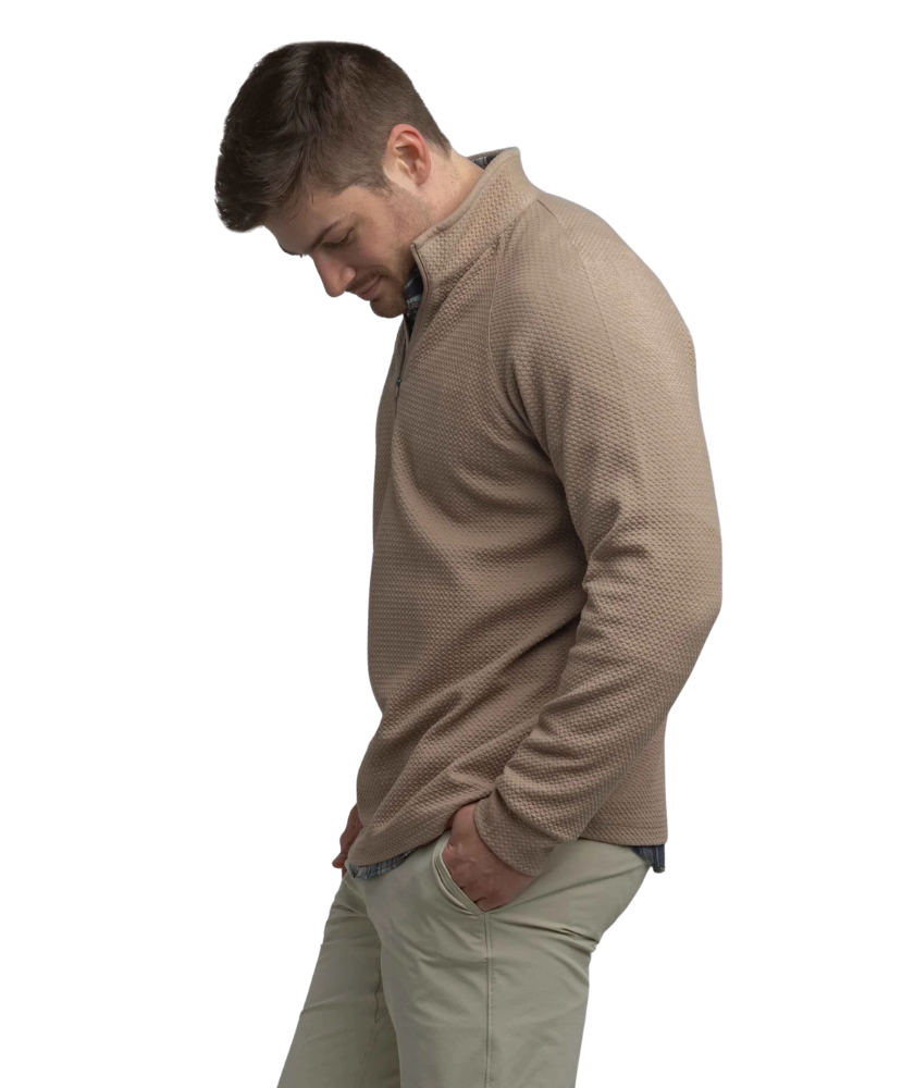 Man wearing a light brown long-sleeve quarter-zip pullover on a white background