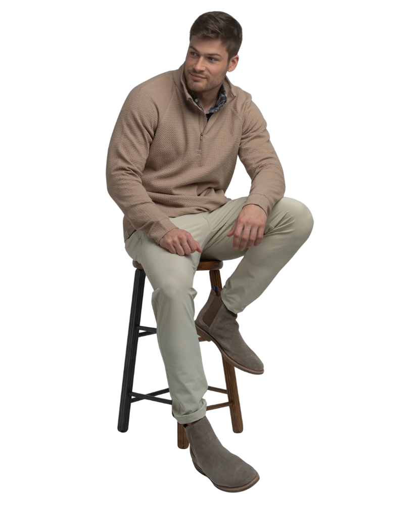 Man wearing a light brown long-sleeve quarter-zip pullover on a white background