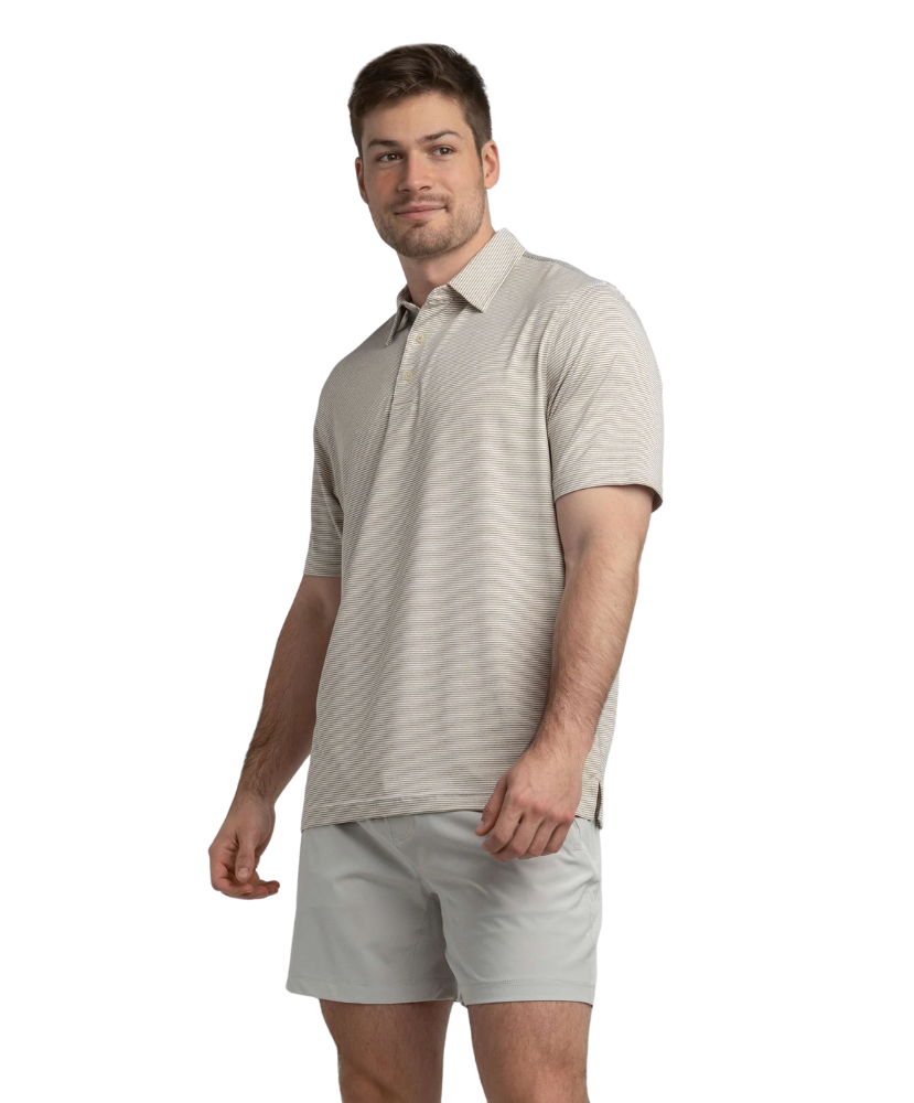 Man wearing a beige polo shirt and shorts on a white background