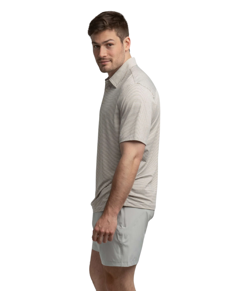 Man wearing a gray polo shirt and shorts on a white background
