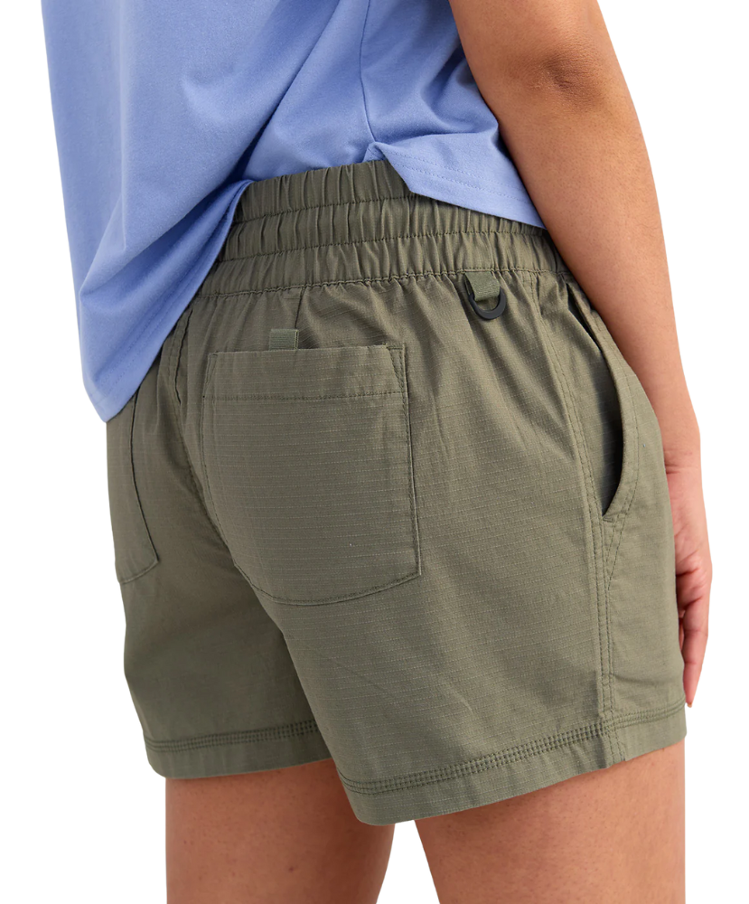 woman wearing olive green shorts on a white background