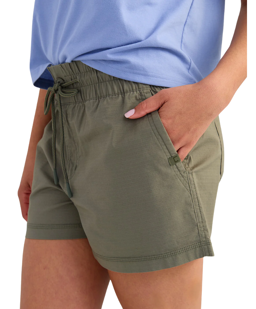 woman wearing olive green shorts on a white background