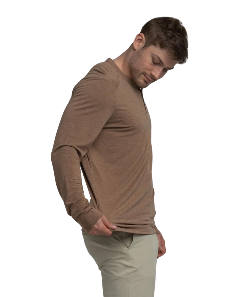 Man wearing a brown long-sleeve henley shirt and beige pants on a white background