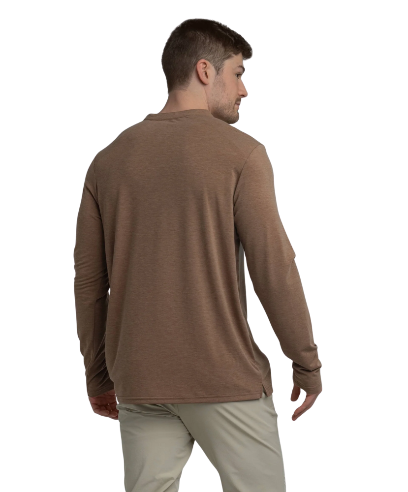 Man wearing a brown long-sleeve henlry shirt on a white background