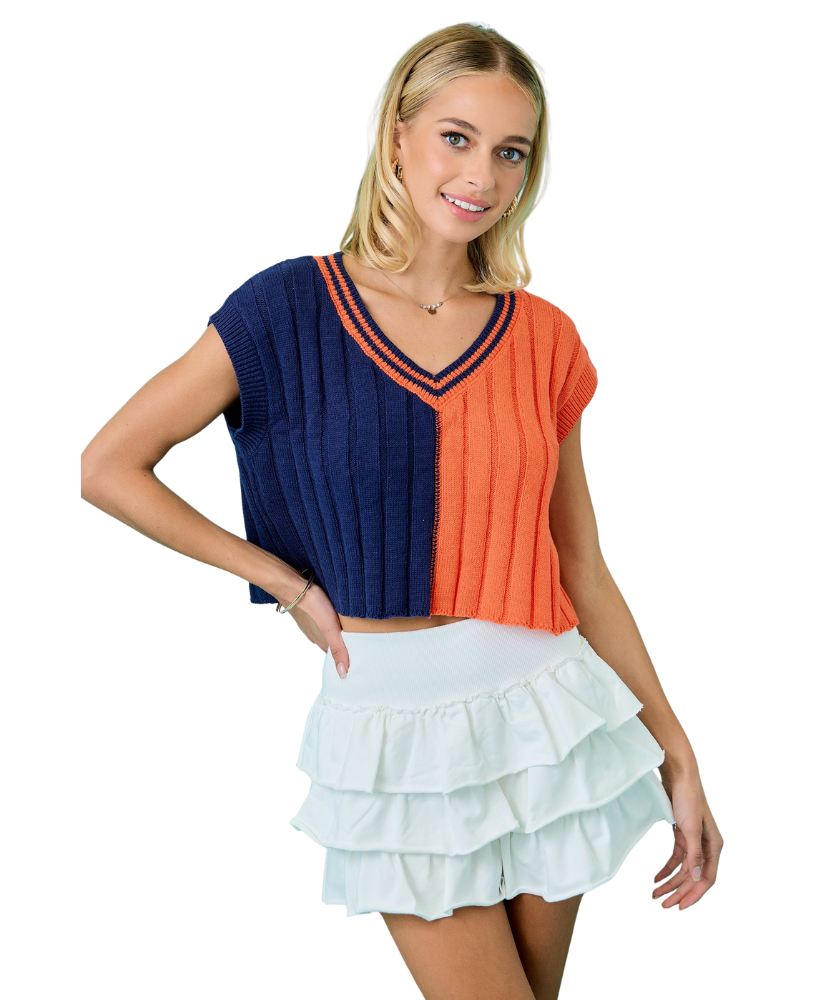 Woman wearing a two-tone top with blue and orange colors on a white background