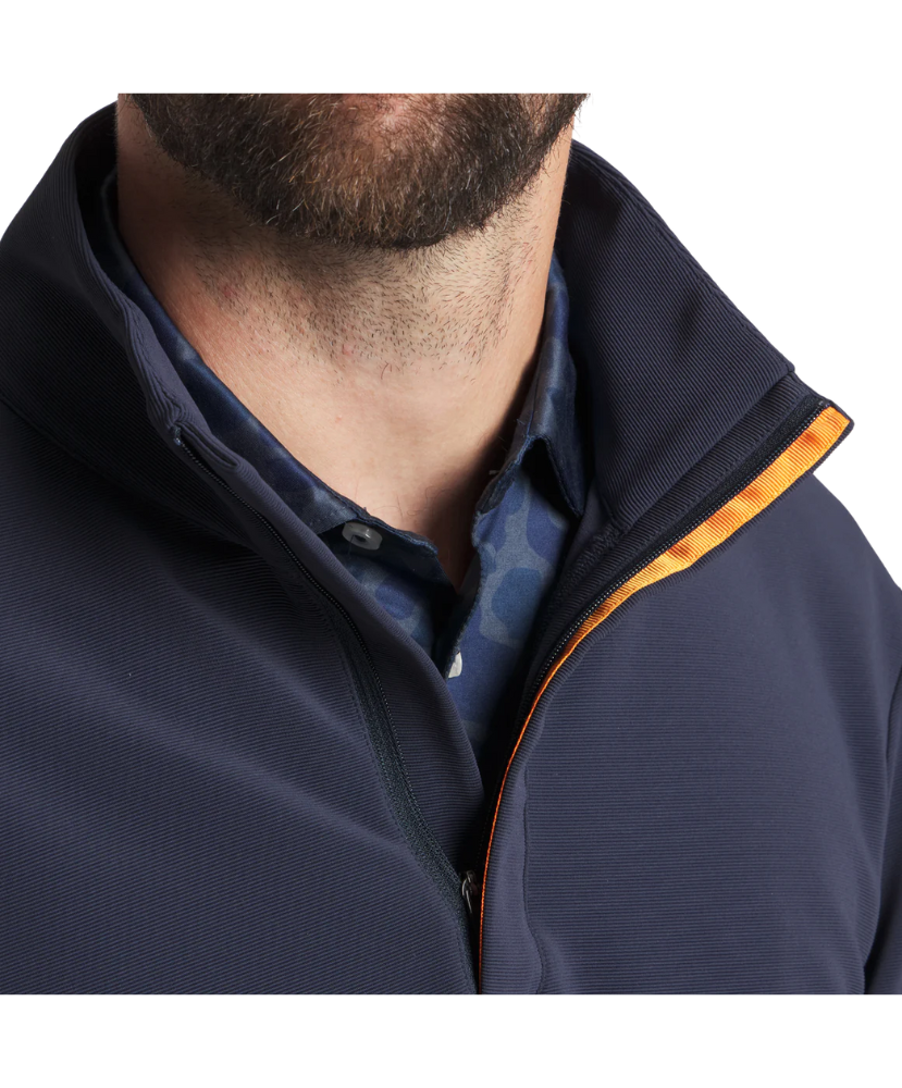 Man wearing a navy blue pullover with a white background