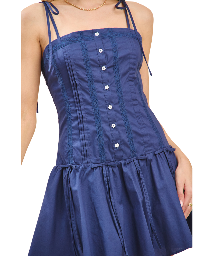 Blue dress with button details on a white background