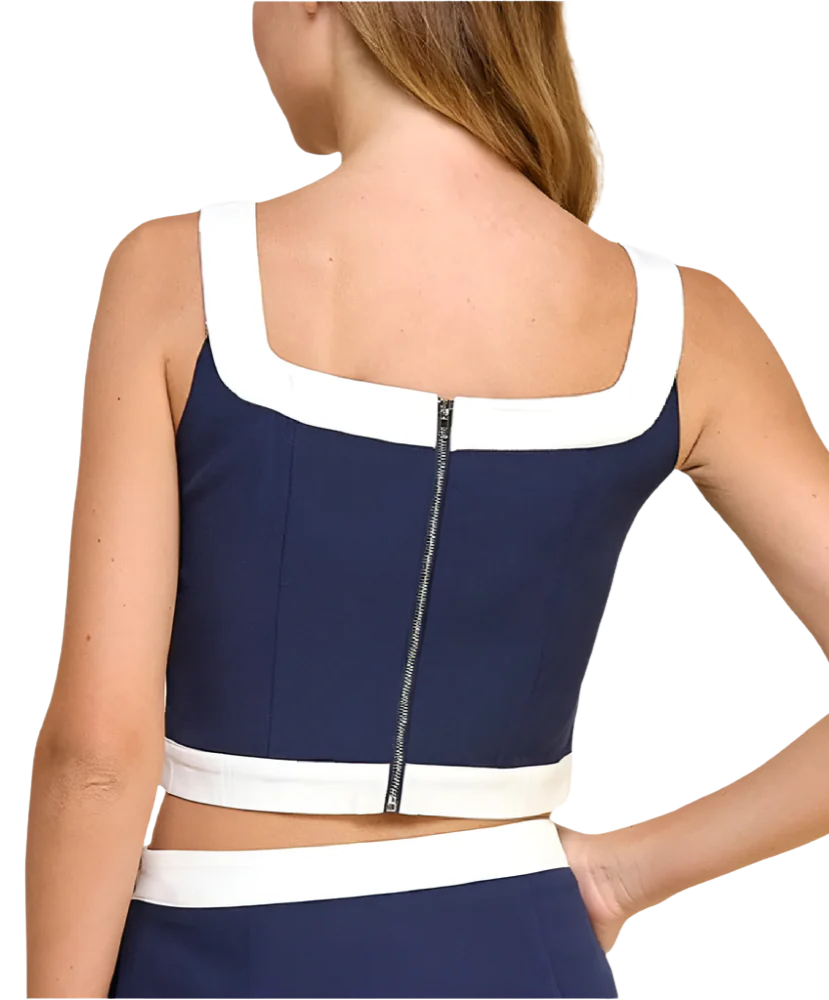 Navy and white crop top with zipper detail on a plain background