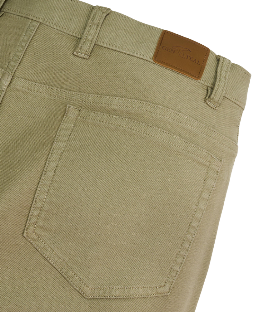 Close-up of olive green pants with a GenTeal brand label on a white background