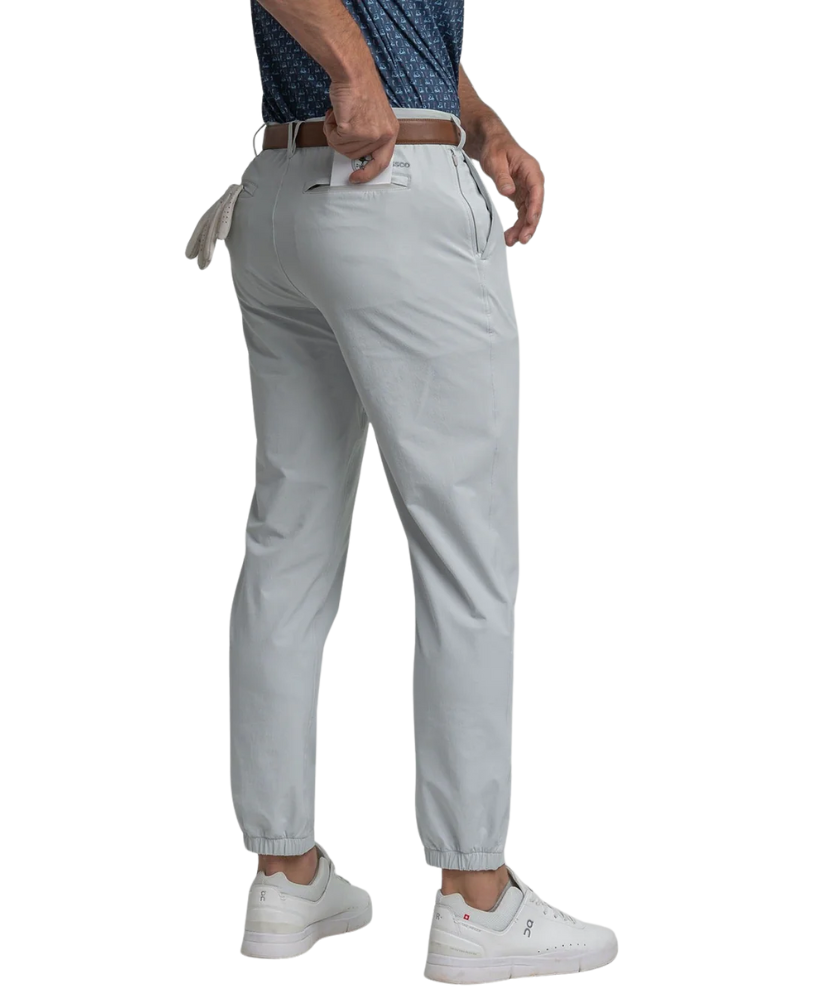 Light gray performance jogger pants worn by a person on a white background