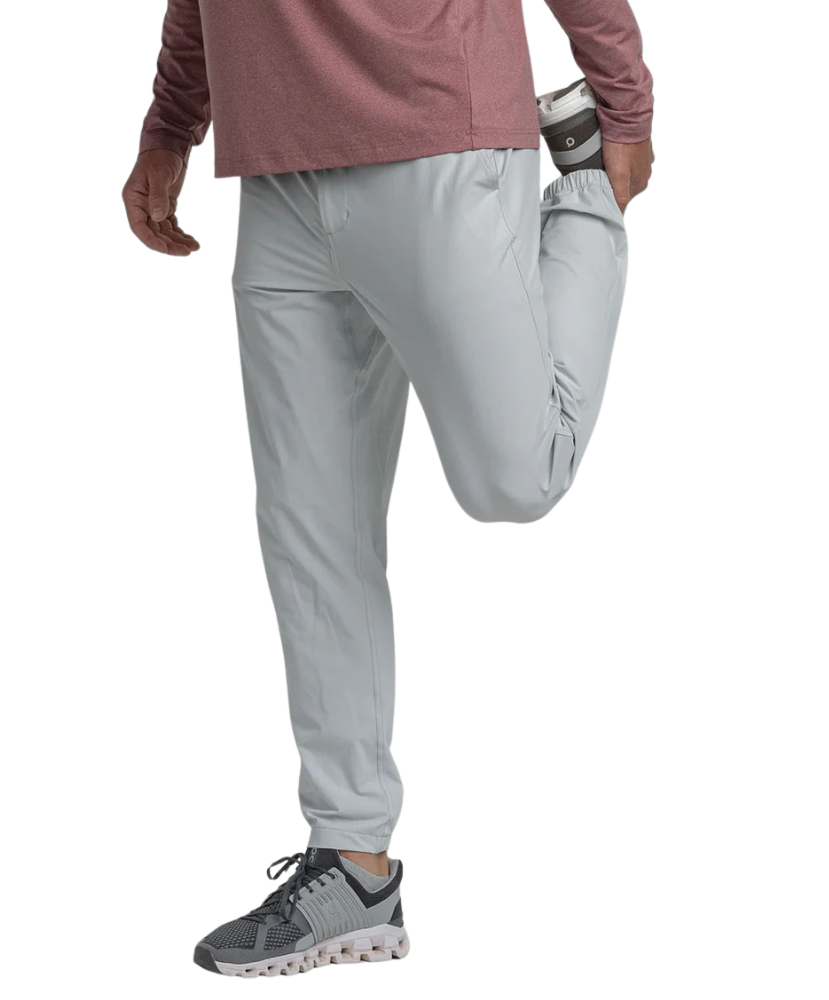 Light gray performance jogger pants worn by a person on a white background