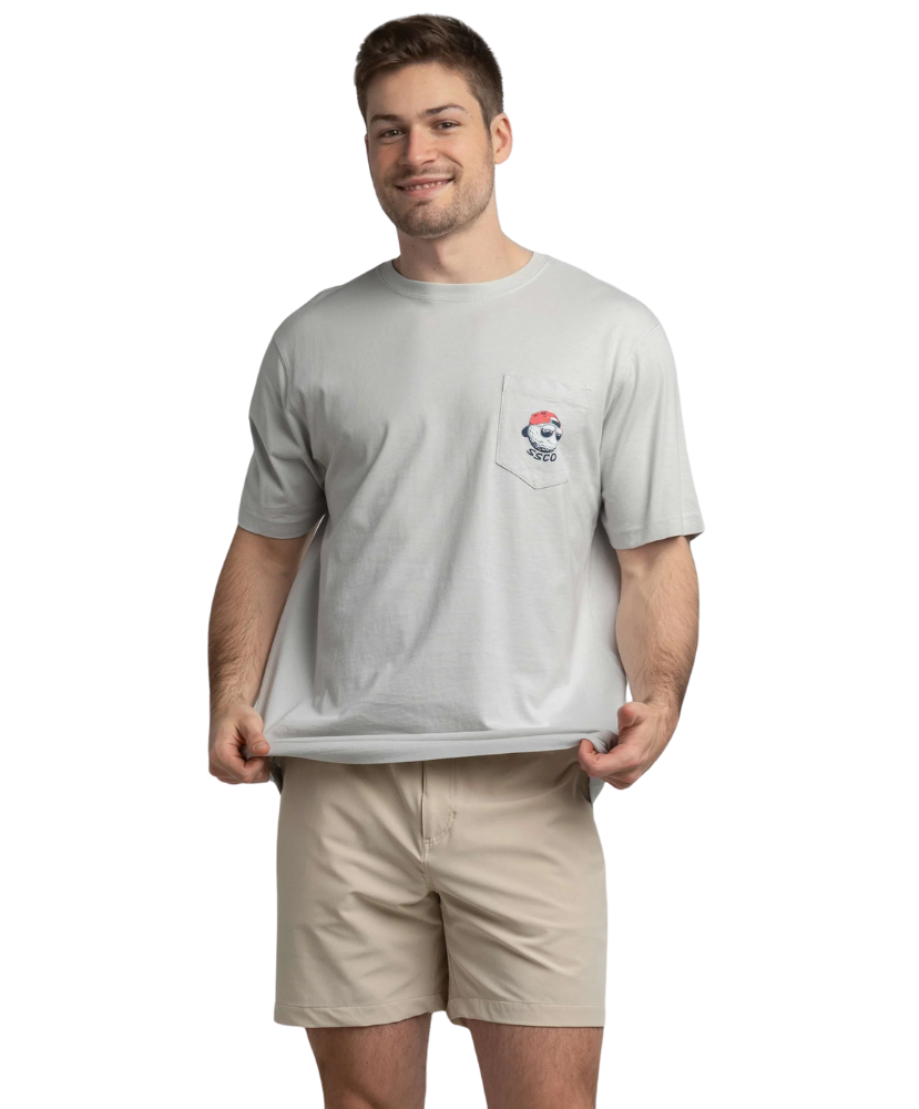 Man wearing a gray t-shirt with a logo and beige shorts on a white background