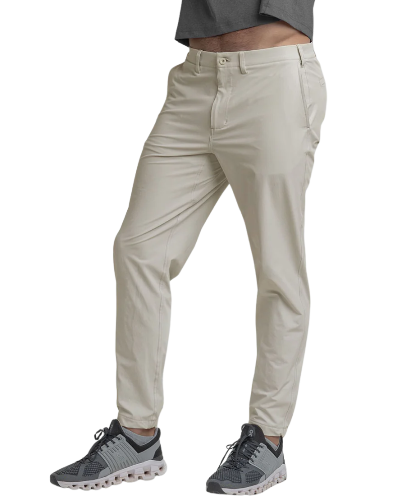 Beige Nomad Performance Jogger pants worn by a person on a white background