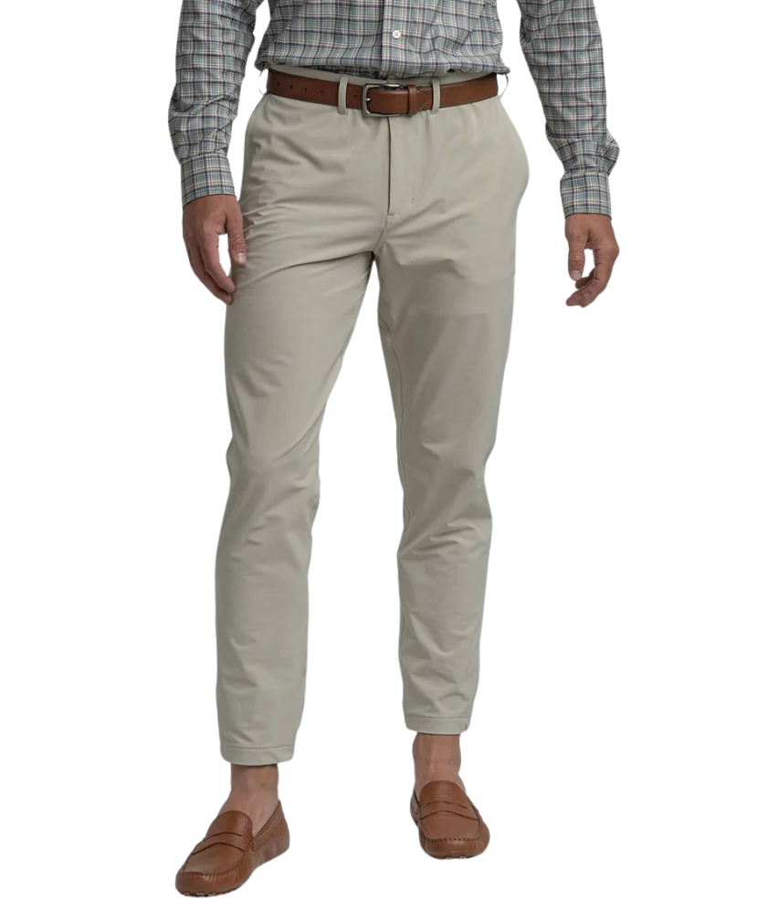 Beige Nomad Performance Jogger pants worn by a person on a white background
