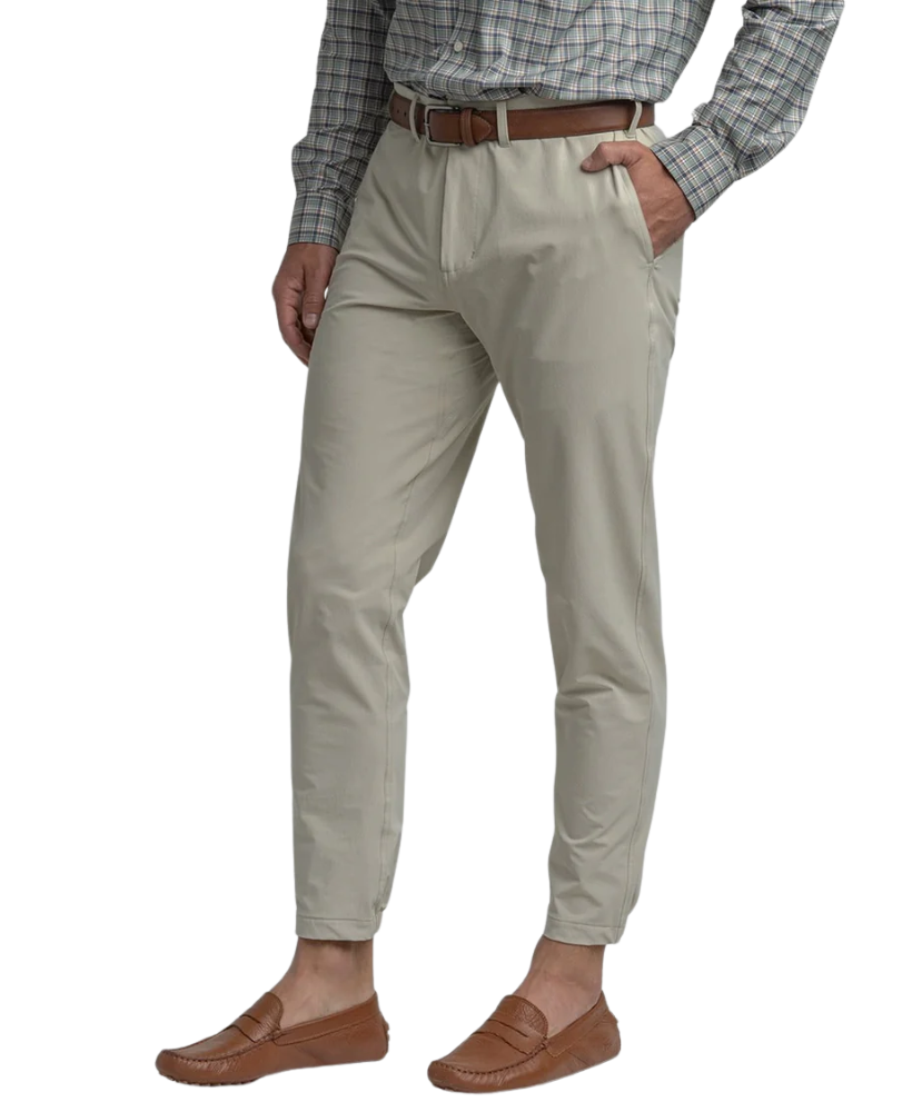 Beige Nomad Performance Jogger pants worn by a person on a white background