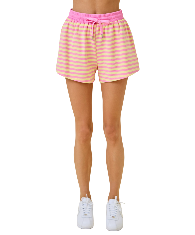 Pink and yellow striped shorts worn by a person on a white background