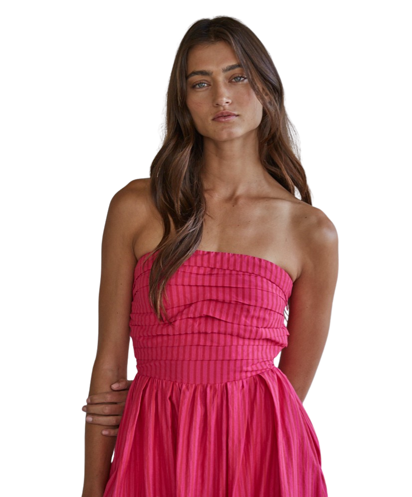 Woman wearing a pink strapless dress on a white background