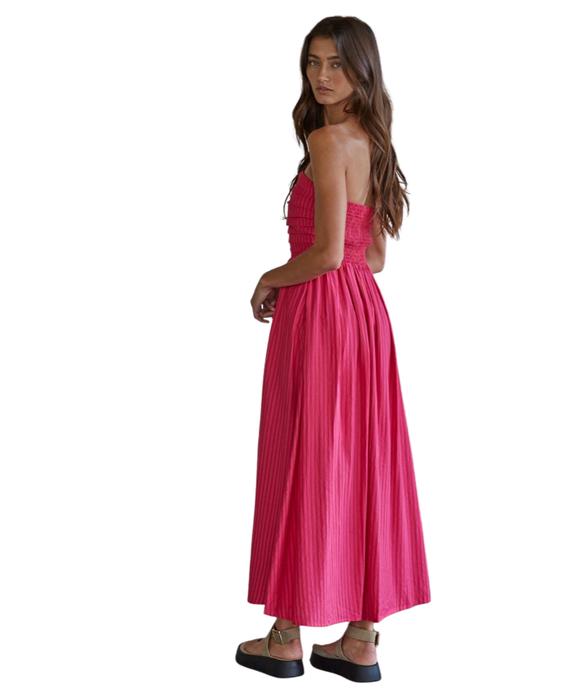 Woman wearing a pink strapless dress on a white background